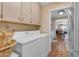 Convenient laundry area with ample cabinet space and a view into the kitchen and dining area at 2966 S Country Club Way, Tempe, AZ 85282