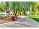 Scenic park pathway with a pet waste station, winding through lush greenery, promoting responsible pet ownership and a clean environment at 2966 S Country Club Way, Tempe, AZ 85282