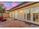 Cozy patio with multiple entry doors and exterior lighting fixtures for evening entertainment at 2966 S Country Club Way, Tempe, AZ 85282