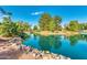 Picturesque pond scene with clear blue water, surrounded by trees and rocks, creating a calming and inviting recreational area at 2966 S Country Club Way, Tempe, AZ 85282