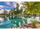 Scenic pond reflecting trees and sky, framed by rocky shores and greenery, offering a serene and inviting natural setting at 2966 S Country Club Way, Tempe, AZ 85282