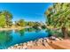 Scenic pond with lush trees and rocks, offering a calming and refreshing outdoor oasis for relaxation and recreation at 2966 S Country Club Way, Tempe, AZ 85282