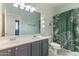 Bright bathroom with a double vanity, leaf-patterned shower curtain, and ample counter space at 3062 E Cullumber St, Gilbert, AZ 85234