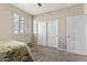 Neutral bedroom with plantation shutters, white sliding closet doors, and soft carpet at 3062 E Cullumber St, Gilbert, AZ 85234