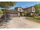 Traditional two-story home with attached two-car garage, manicured lawn, and mature trees at 3062 E Cullumber St, Gilbert, AZ 85234
