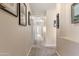 Bright hallway with neutral walls and carpet, decorated with framed artwork at 3062 E Cullumber St, Gilbert, AZ 85234