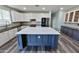 Modern kitchen features white cabinets, stainless steel appliances, and a large central island with a white countertop at 3062 E Cullumber St, Gilbert, AZ 85234
