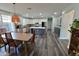 Bright, open-concept kitchen with a dining area, featuring white cabinets, stainless appliances, and a large island at 3062 E Cullumber St, Gilbert, AZ 85234