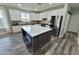 Well-lit kitchen with a large island, stainless steel appliances, white cabinets, and modern flooring at 3062 E Cullumber St, Gilbert, AZ 85234