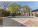 Sparkling pool with patio, and seating under umbrella at 3062 E Cullumber St, Gilbert, AZ 85234