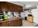 Functional kitchen featuring wooden cabinets, white appliances, and an island counter at 3262 E Enid Ave, Mesa, AZ 85204