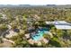 Community aerial view including the community pool, tennis courts, and surrounding residential area at 3935 E Rough Rider Rd # 1076, Phoenix, AZ 85050