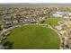 Expansive aerial view of the community with a large green space and residential homes at 3935 E Rough Rider Rd # 1076, Phoenix, AZ 85050