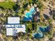 Aerial view of the community pool, recreation center, tennis court and playground surrounded by trees at 3935 E Rough Rider Rd # 1076, Phoenix, AZ 85050