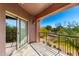 View of private balcony overlooking desert landscape with iron railing and a sliding glass door at 3935 E Rough Rider Rd # 1076, Phoenix, AZ 85050