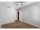 Bedroom includes neutral walls, carpet, ceiling fan, closet, and a white door at 3935 E Rough Rider Rd # 1076, Phoenix, AZ 85050
