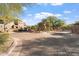 A welcoming community entrance with a stone paved road, desert landscaping and a gate at 3935 E Rough Rider Rd # 1076, Phoenix, AZ 85050