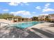 Resort-style community pool with lounge chairs, lush landscaping, and inviting blue water at 3935 E Rough Rider Rd # 1076, Phoenix, AZ 85050
