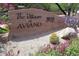 A charming community sign, 'The Villages at Aviano 3935,' with desert landscaping at 3935 E Rough Rider Rd # 1076, Phoenix, AZ 85050