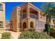 A beautiful two-story home with a private balcony, neutral stucco and covered entryway at 3935 E Rough Rider Rd # 1076, Phoenix, AZ 85050