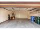 Clean, empty garage featuring storage shelves and blue and green waste bins at 3935 E Rough Rider Rd # 1076, Phoenix, AZ 85050