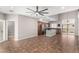 An open-concept living space includes a full kitchen with island, tile floors and ceiling fan at 3935 E Rough Rider Rd # 1076, Phoenix, AZ 85050