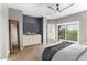 Light-filled main bedroom with a ceiling fan and a sliding glass door to a balcony at 3935 E Rough Rider Rd # 1076, Phoenix, AZ 85050