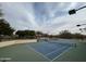 Well-maintained tennis court surrounded by trees and fencing for privacy at 3935 E Rough Rider Rd # 1076, Phoenix, AZ 85050