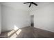 Neutral bedroom featuring carpet, a ceiling fan, and two doorways at 4111 N 313Th Ave, Buckeye, AZ 85396
