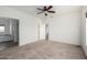 Spacious bedroom features neutral carpeting, ceiling fan and ensuite bath at 4111 N 313Th Ave, Buckeye, AZ 85396