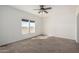 Bedroom with neutral carpet, windows, and a ceiling fan at 4111 N 313Th Ave, Buckeye, AZ 85396