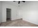 Bedroom with carpet, ceiling fan, and door to walk-in closet at 4111 N 313Th Ave, Buckeye, AZ 85396