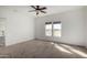 Bedroom featuring neutral carpet, a ceiling fan, and natural light at 4111 N 313Th Ave, Buckeye, AZ 85396