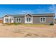 Charming single-story home featuring a well-manicured lawn and a welcoming entrance with lots of windows at 4111 N 313Th Ave, Buckeye, AZ 85396