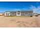 Charming single-story home featuring a well-manicured lawn and a welcoming entrance with lots of windows at 4111 N 313Th Ave, Buckeye, AZ 85396