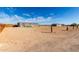 Expansive lot with a manufactured home in the distance, offering ample space for outdoor activities at 4111 N 313Th Ave, Buckeye, AZ 85396
