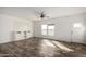 Bright, airy living room with vinyl floors, recessed lighting, and custom built ins at 4111 N 313Th Ave, Buckeye, AZ 85396