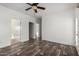 Open living room featuring a contemporary ceiling fan and wood-look floors at 4111 N 313Th Ave, Buckeye, AZ 85396