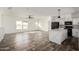 Open living room and kitchen area with wood flooring and a large island at 4111 N 313Th Ave, Buckeye, AZ 85396
