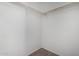 This walk-in closet features a wooden clothes rack, white walls, and gray carpet flooring at 4111 N 313Th Ave, Buckeye, AZ 85396