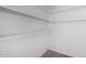 This walk-in closet has white walls, carpet flooring, and white shelving at 4111 N 313Th Ave, Buckeye, AZ 85396