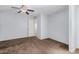 Bedroom with carpet, ceiling fan, and access to the bathroom at 4116 N 105Th Ln, Phoenix, AZ 85037