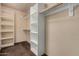 Walk-in closet featuring custom shelving units for optimal storage at 4116 N 105Th Ln, Phoenix, AZ 85037