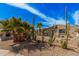 A single-story home with desert landscaping, and a quaint front entrance and window at 4116 N 105Th Ln, Phoenix, AZ 85037
