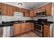 Spacious kitchen featuring stainless steel appliances, marble backsplash, and wooden cabinets at 4116 N 105Th Ln, Phoenix, AZ 85037
