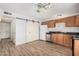 The kitchen features tile flooring, stainless steel appliances, and sliding barn doors at 4116 N 105Th Ln, Phoenix, AZ 85037