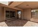 Inviting covered patio with brick flooring, perfect for outdoor entertaining and relaxing at 4116 N 105Th Ln, Phoenix, AZ 85037