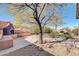 Spacious backyard featuring a unique outdoor fireplace with seating and desert-style landscape at 4365 S Columbine Way, Gold Canyon, AZ 85118