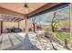 Covered patio showcases built-in fireplace, lush landscaping and desert views at 4365 S Columbine Way, Gold Canyon, AZ 85118