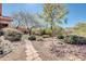 Scenic backyard with desert landscaping, stone pathway and comfortable outdoor living space at 4365 S Columbine Way, Gold Canyon, AZ 85118